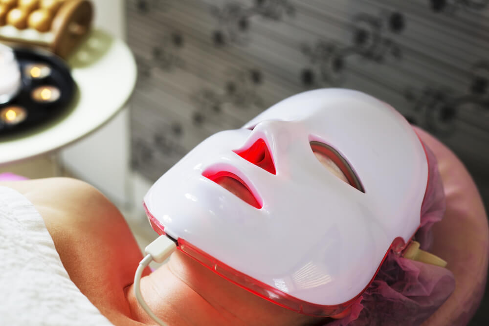 a woman received red LED Opera Mask Therapy